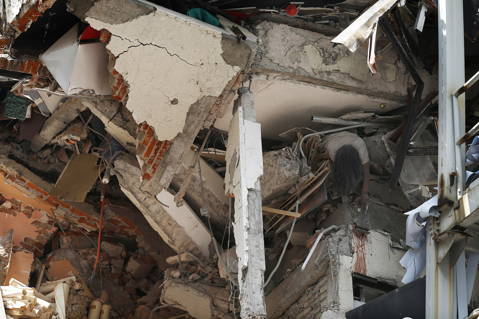 A heartbreaking image shows a victim in a collapsed building in Mexico City, illustrating the deadly impact of the earthquake.