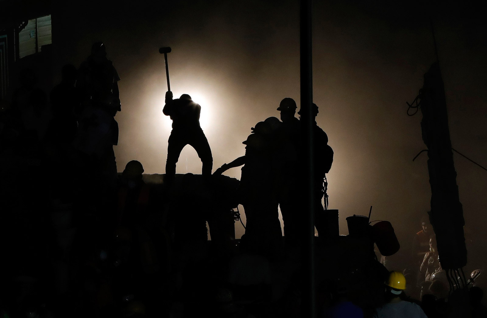 Rescuers search for victims beneath a collapsed building in Mexico City after the 2017 earthquake.