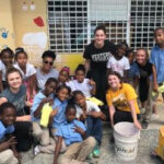 A WMU student with a group of local children in a school in Dominican Republic.