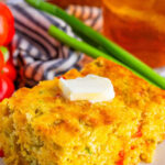 A small plate with a large piece of Mexican Cornbread.