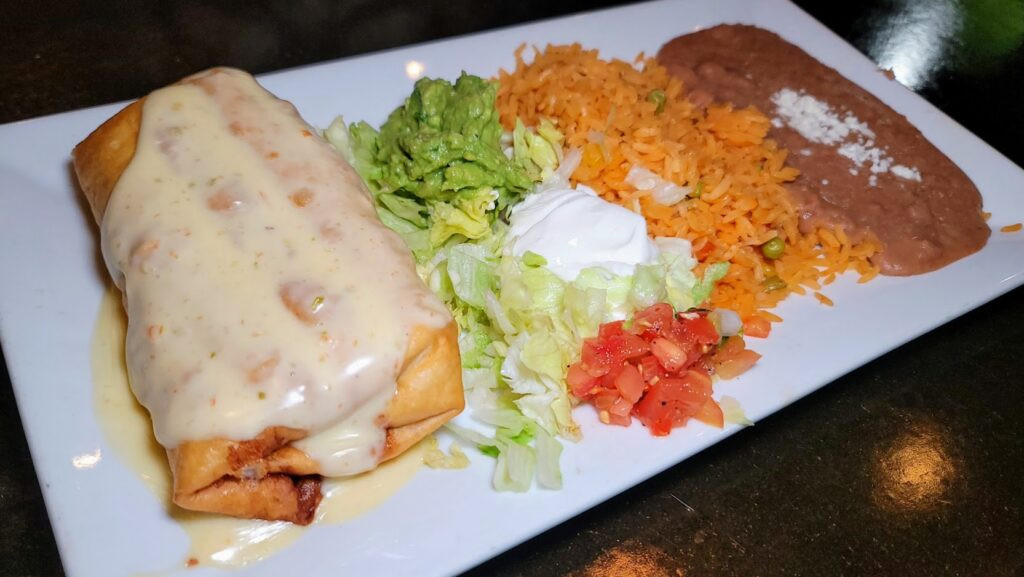 Chimichanga covered in queso at El Rey Mexican Restaurant