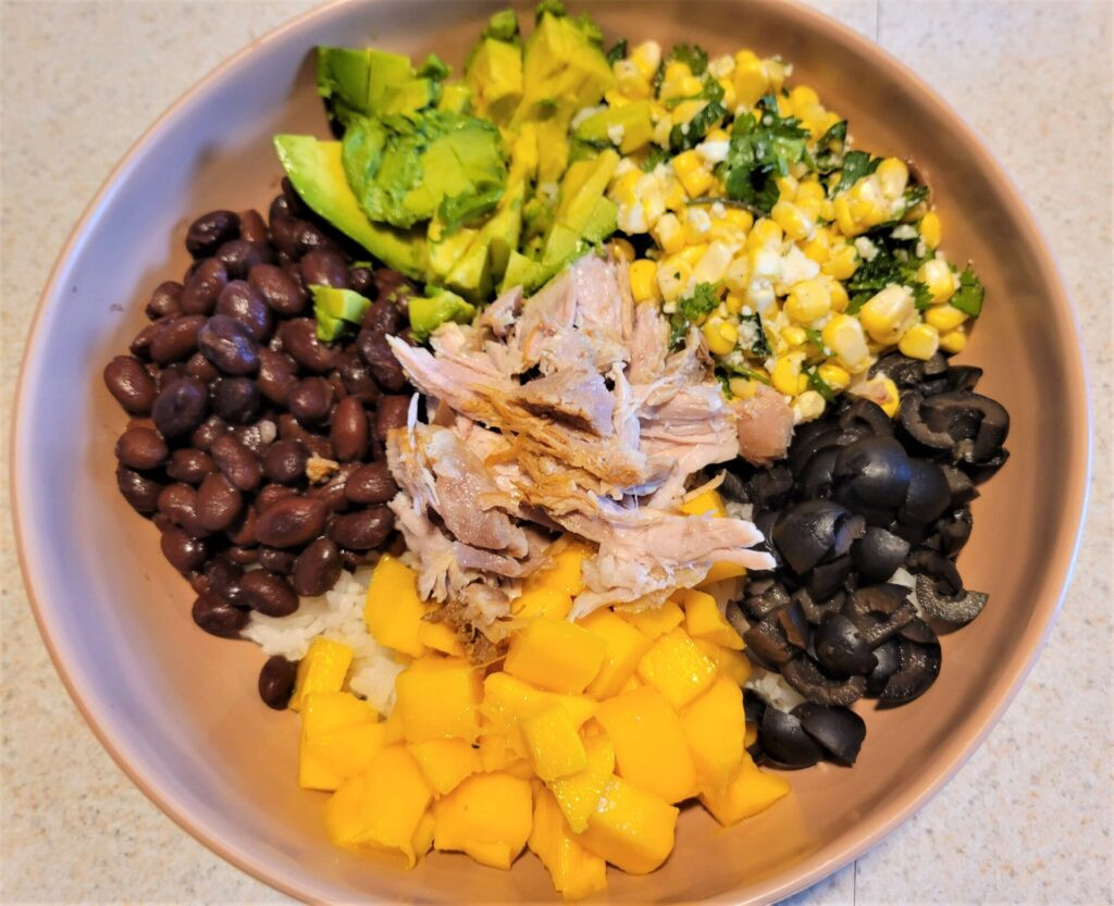 Rice bowl with carnitas, avocado, mango and other ingredients in Leon Mexico