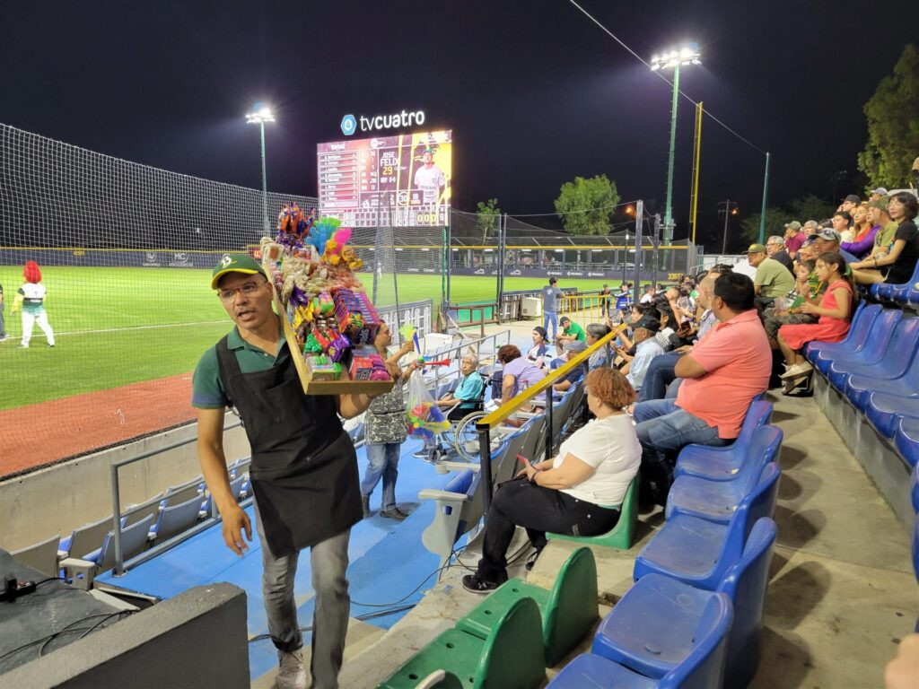 Baseball vendors selling food and drinks in stadium seating in Leon Mexico
