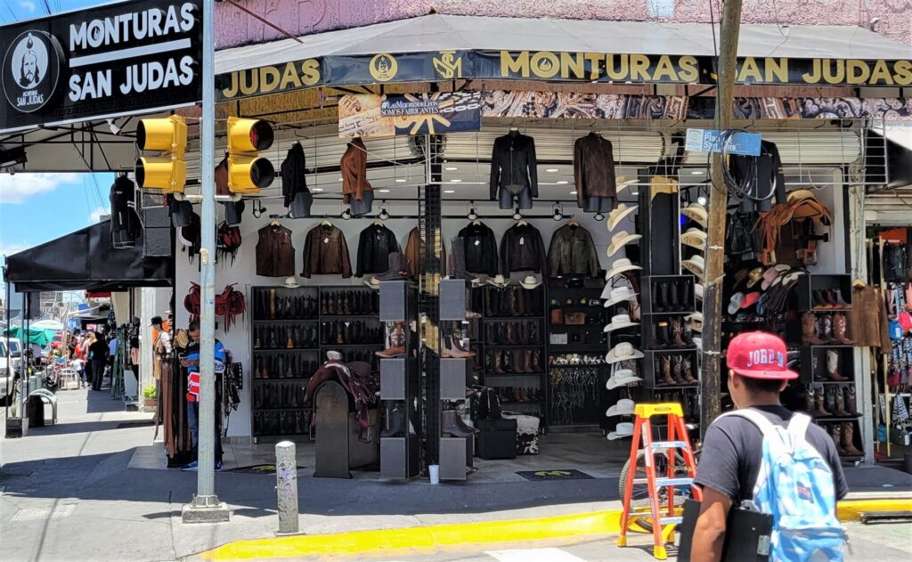 Corner shop selling leather goods including boots, hats, and saddles in Leon Mexico
