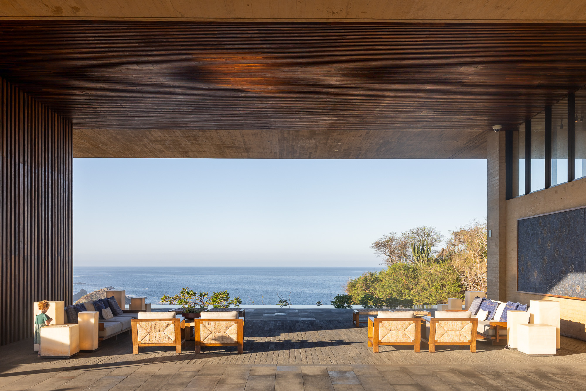 Entrance of Four Seasons Tamarindo with a child posing for scale