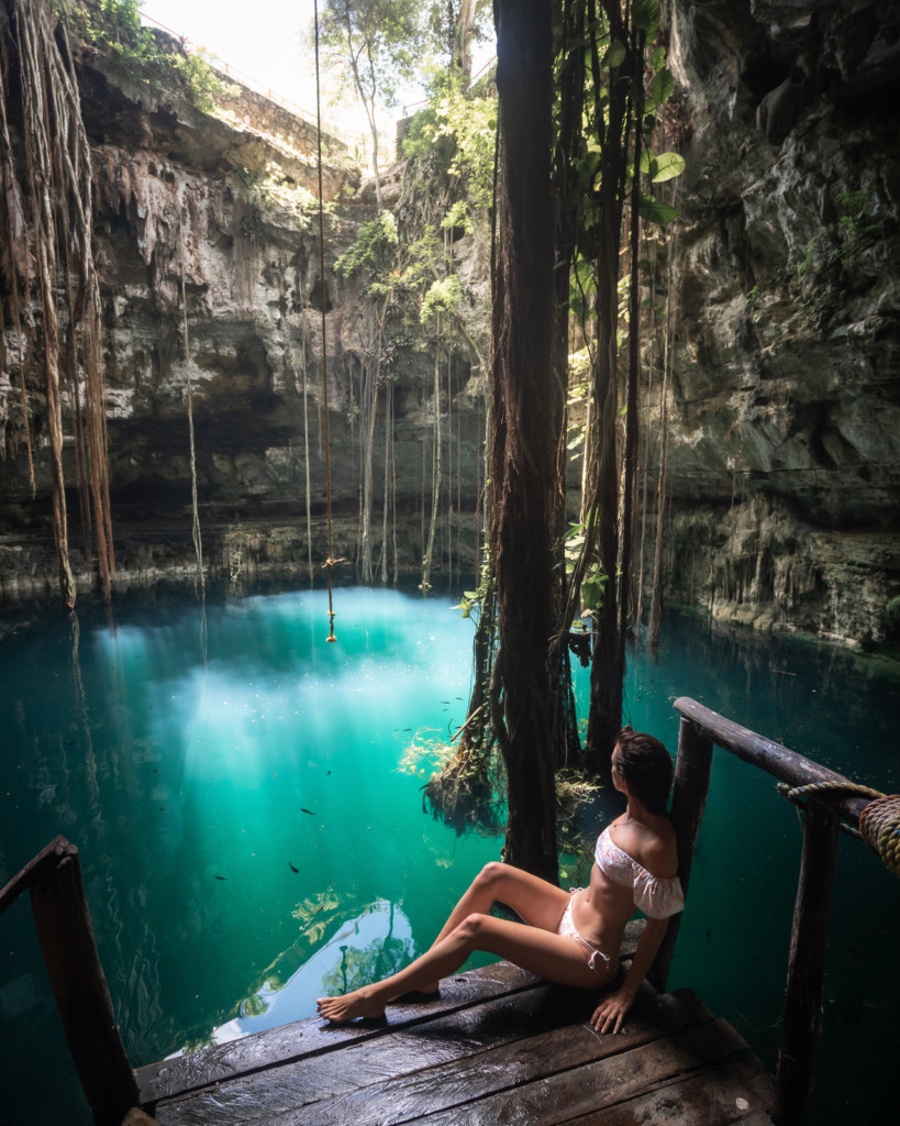 Cenote Oxman, a Yucatan Peninsula highlight, featuring its signature rope swing and sunlit waters.