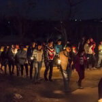 Posada procession with children carrying figures of Mary and Joseph