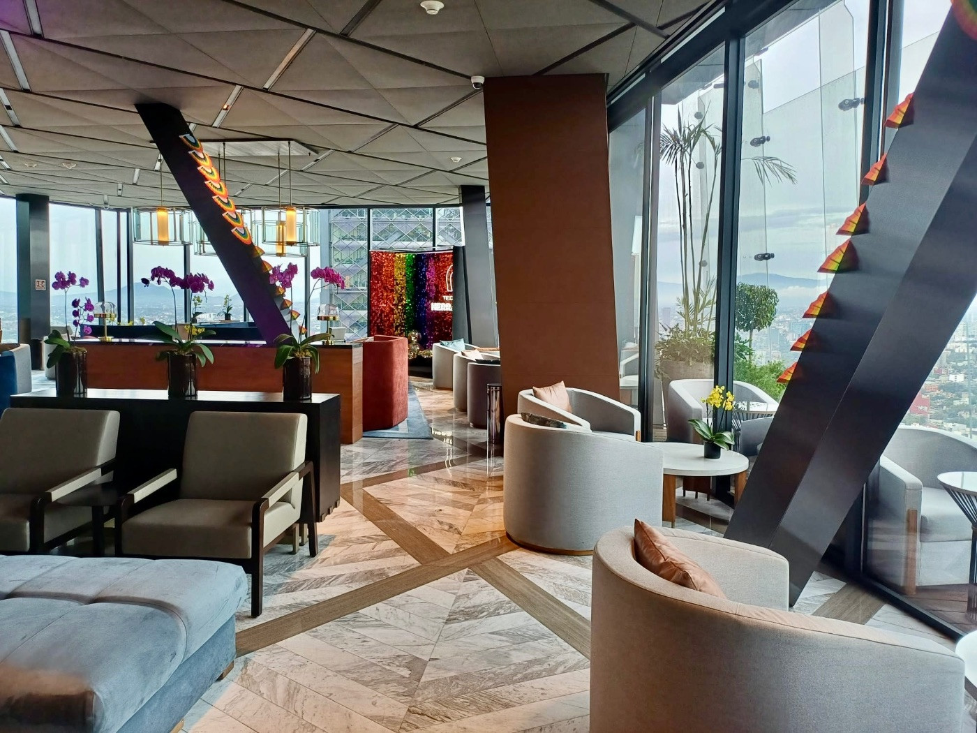 Interior of Samos restaurant at The Ritz-Carlton Mexico City, featuring elegant design and expansive windows for city viewing.