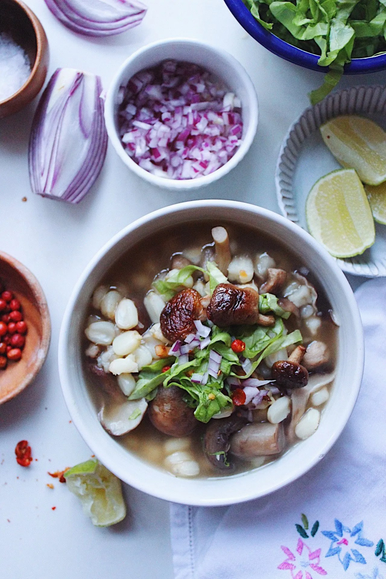 Bowl of flavorful Mexican food Pozole with mushrooms and vibrant toppings