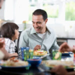 A joyful Mexican family celebrating Father's Day, honoring not just fathers but also father figures.