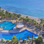 aerial view of The Fives Beach Hotel & Residences with pools and beach access