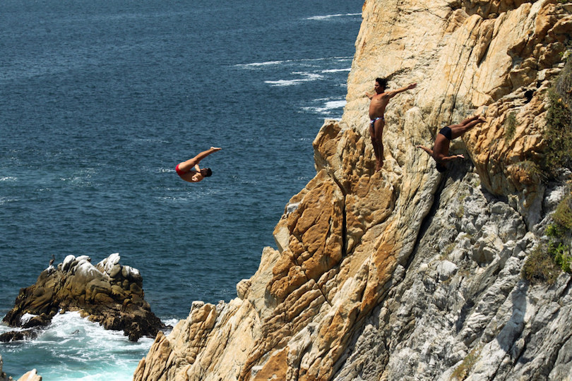 Acapulco cliff divers performing a dive, Acapulco, Mexico