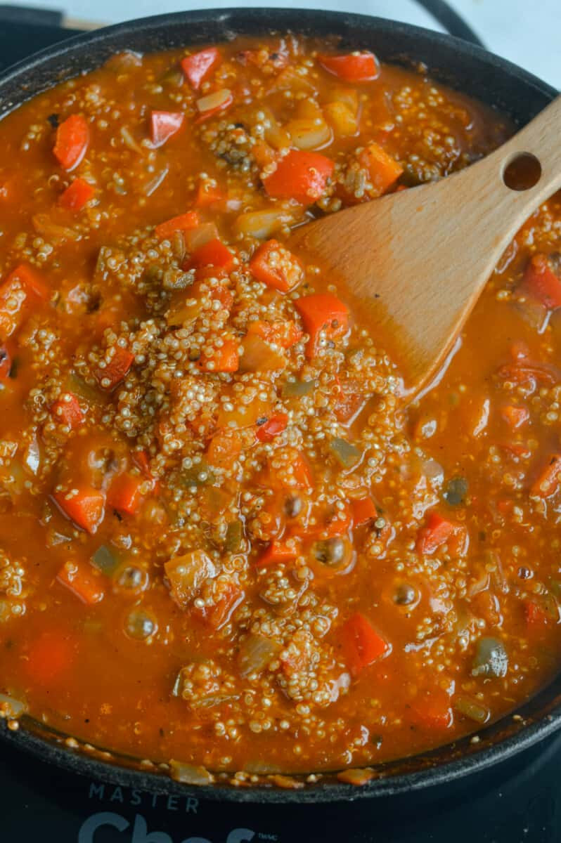 Simmering quinoa in vegetarian mexican taco skillet.