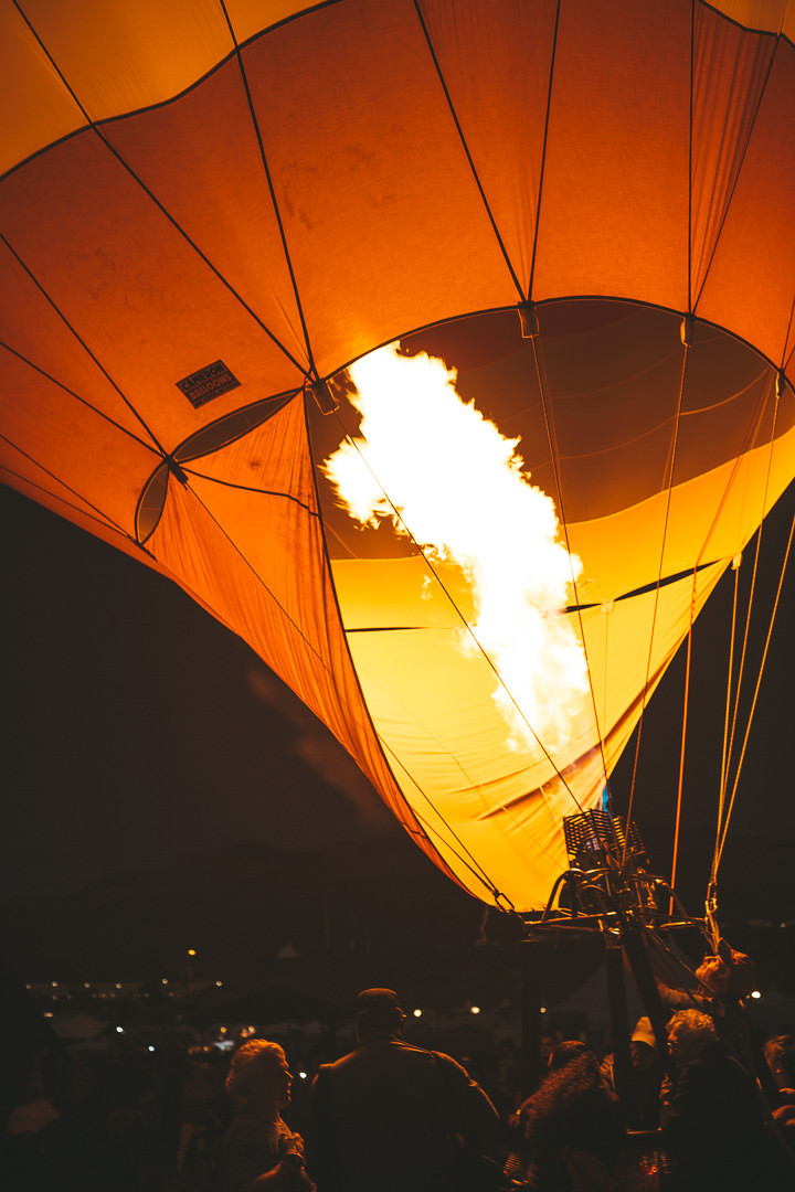 Hot air balloons glowing at night during the Balloon Glow event at the Albuquerque International Balloon Fiesta.