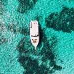 boat in blue water in Roatan Island, Honduras