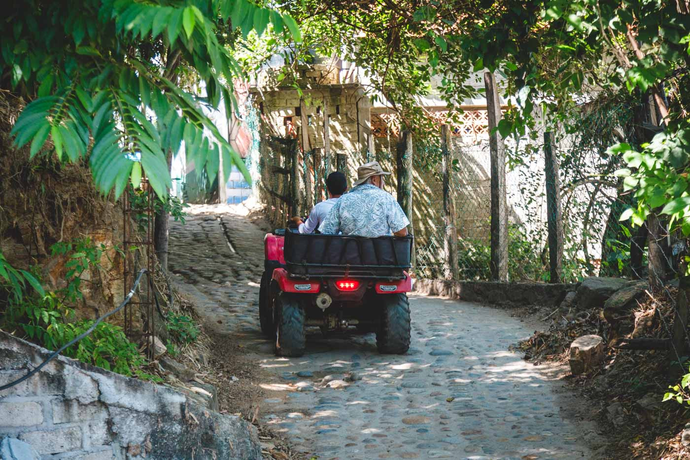 An older tourist enjoying an ATV ride through the streets of Yelapa.