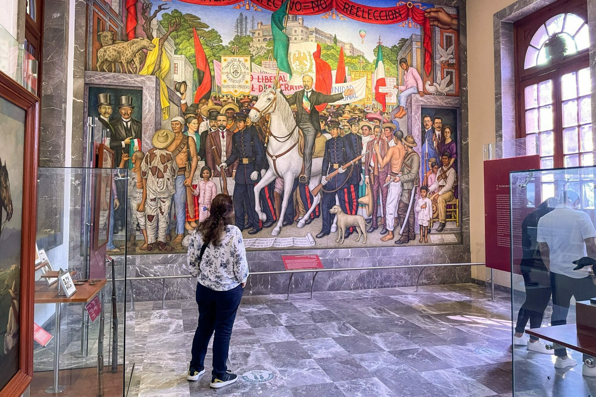 A large mural celebrating the Mexican Revolution in the National Museum of History, depicting key figures and events.