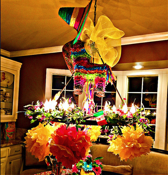 Festive chandelier decoration for a Mexican themed birthday party, featuring tissue paper flowers and a mini pinata.