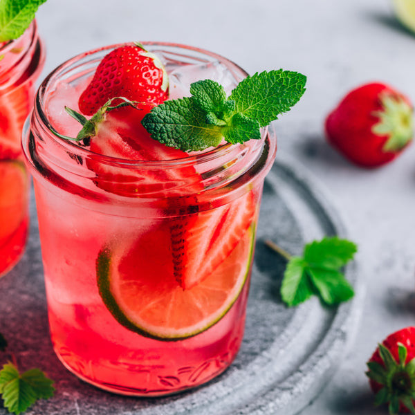 Margaritas served in jelly jars, showcasing a practical and casual serving style for a Mexican party.