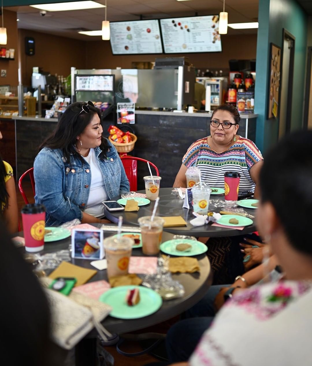 Attendees laughing and enjoying conversation at the New Mexico Piñon Coffee meetup.