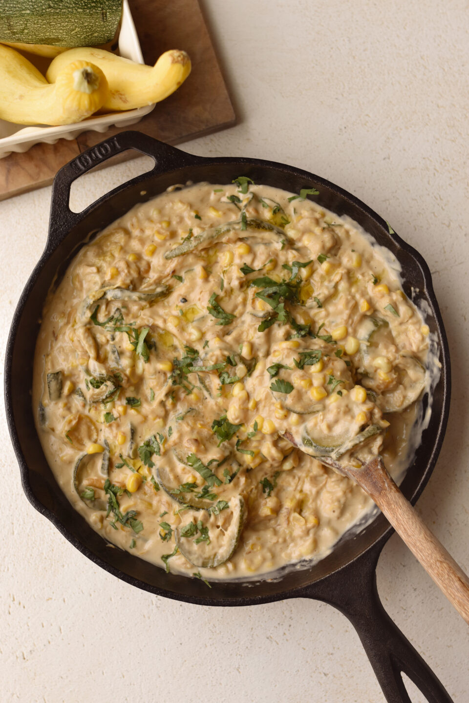 Close-up of Vegan Calabacitas con Crema, a creamy zucchini dish from Mexican cuisine, garnished with fresh cilantro.