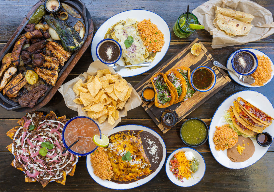 A colorful and appetizing spread of Tex-Mex dishes at Candente in Houston, including flautas and tacos.