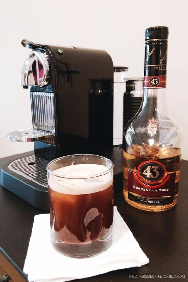 Preparing a Carajillo: Nespresso machine, Licor 43, and iced cocktail ingredients for a perfect mexican coffee drink