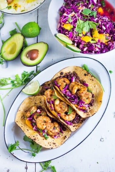 Image of Caribbean Shrimp Tacos with Mango cabbage Slaw and Cuban Style Blackbeans, a healthy and fast dinner idea.
