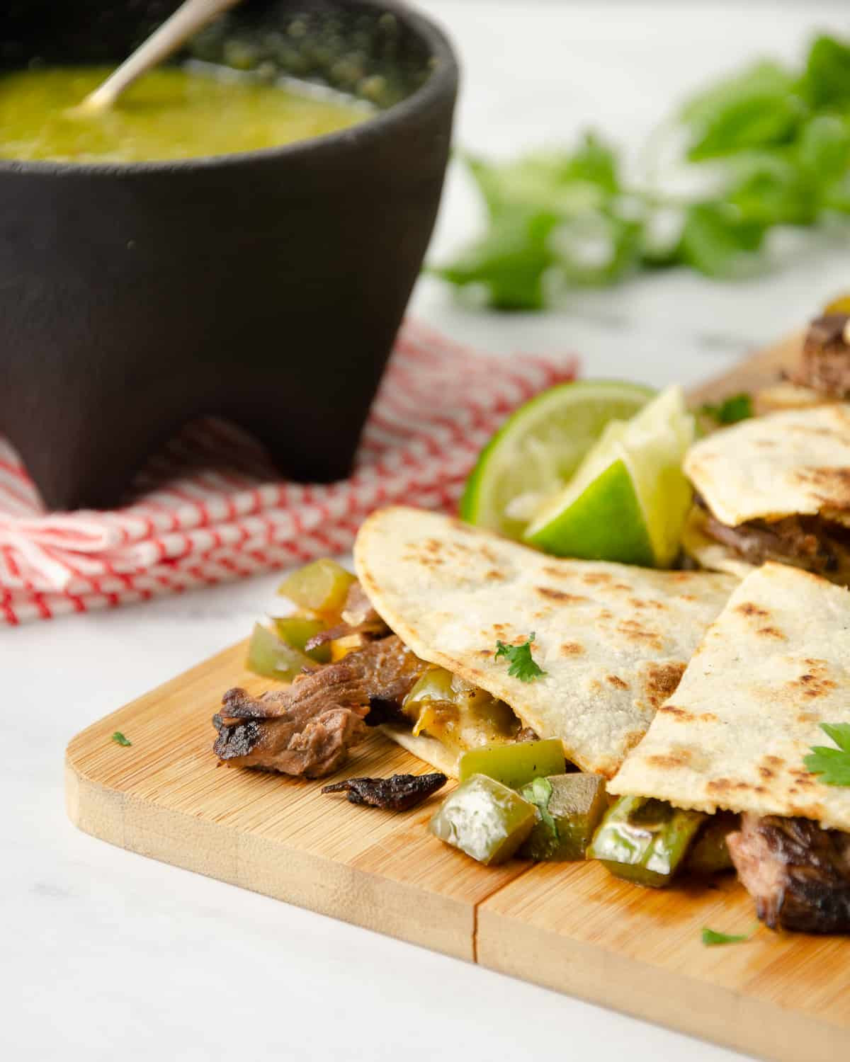 Close up of carne asada inside a cooked quesadilla, showcasing the tender meat.