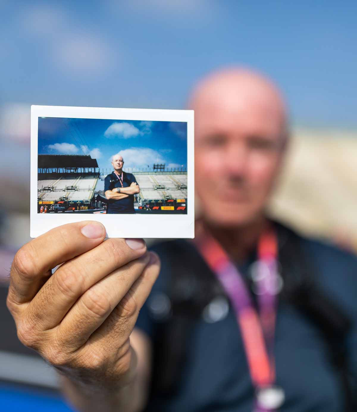 Photographer Charles Leclerc holding a polaroid picture at the Mexican Grand Prix paddock