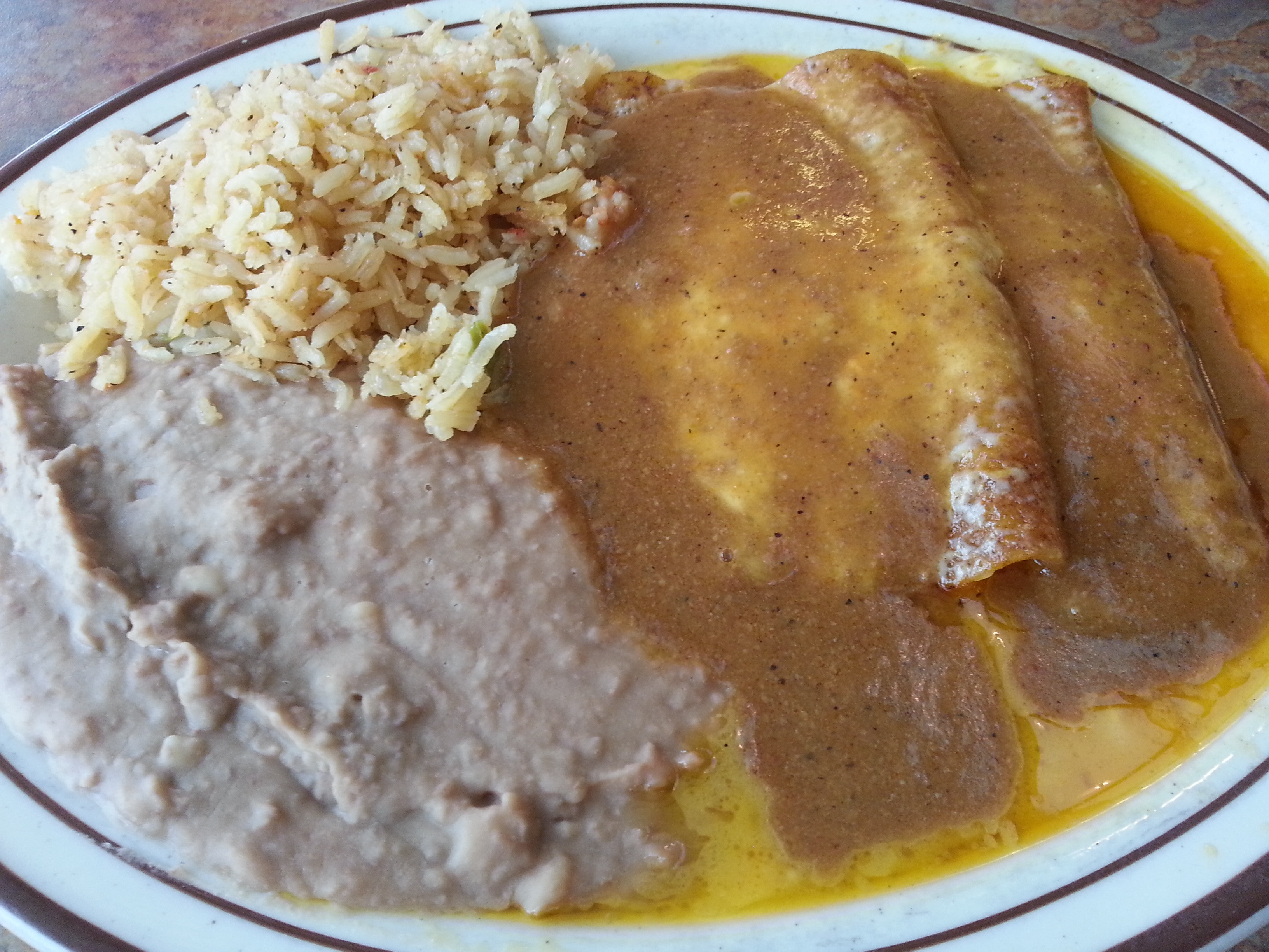 Delicious Cheese Enchiladas with Chili Sauce at Mexican Gardens
