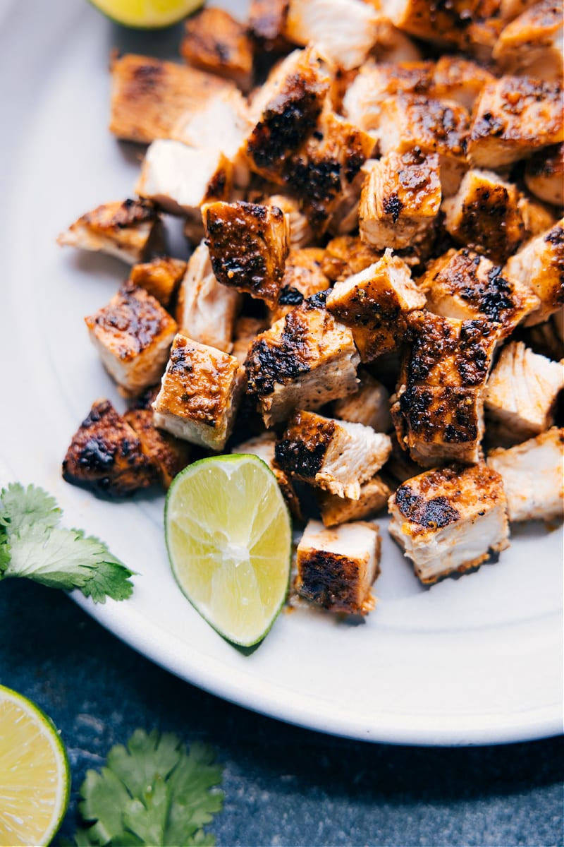 Image of perfectly grilled Mexican chicken taco meat, showcasing the char and vibrant color, plated and ready to be served in tacos