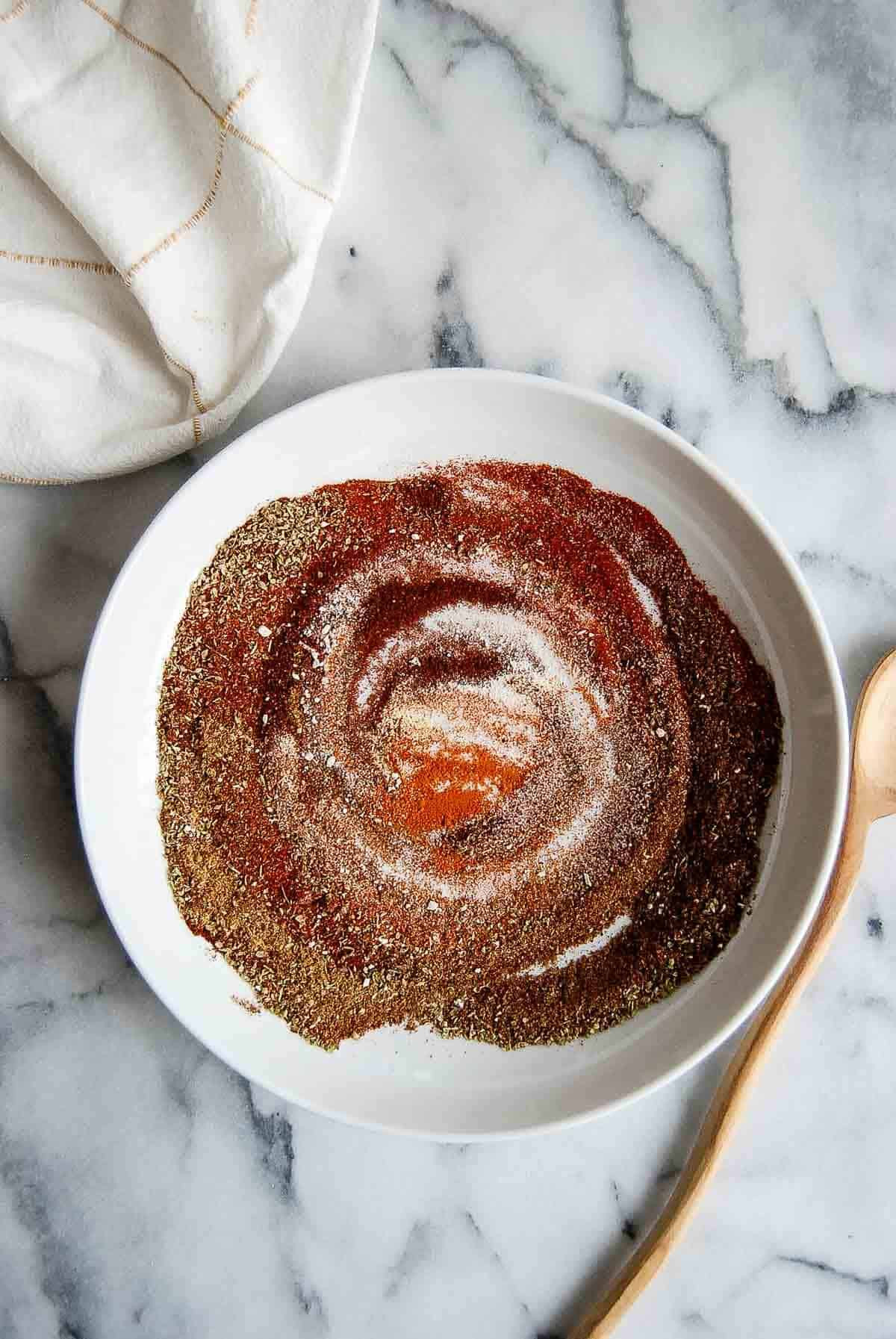 Chicken taco seasoning swirled in a rustic bowl, showcasing its vibrant color and texture.