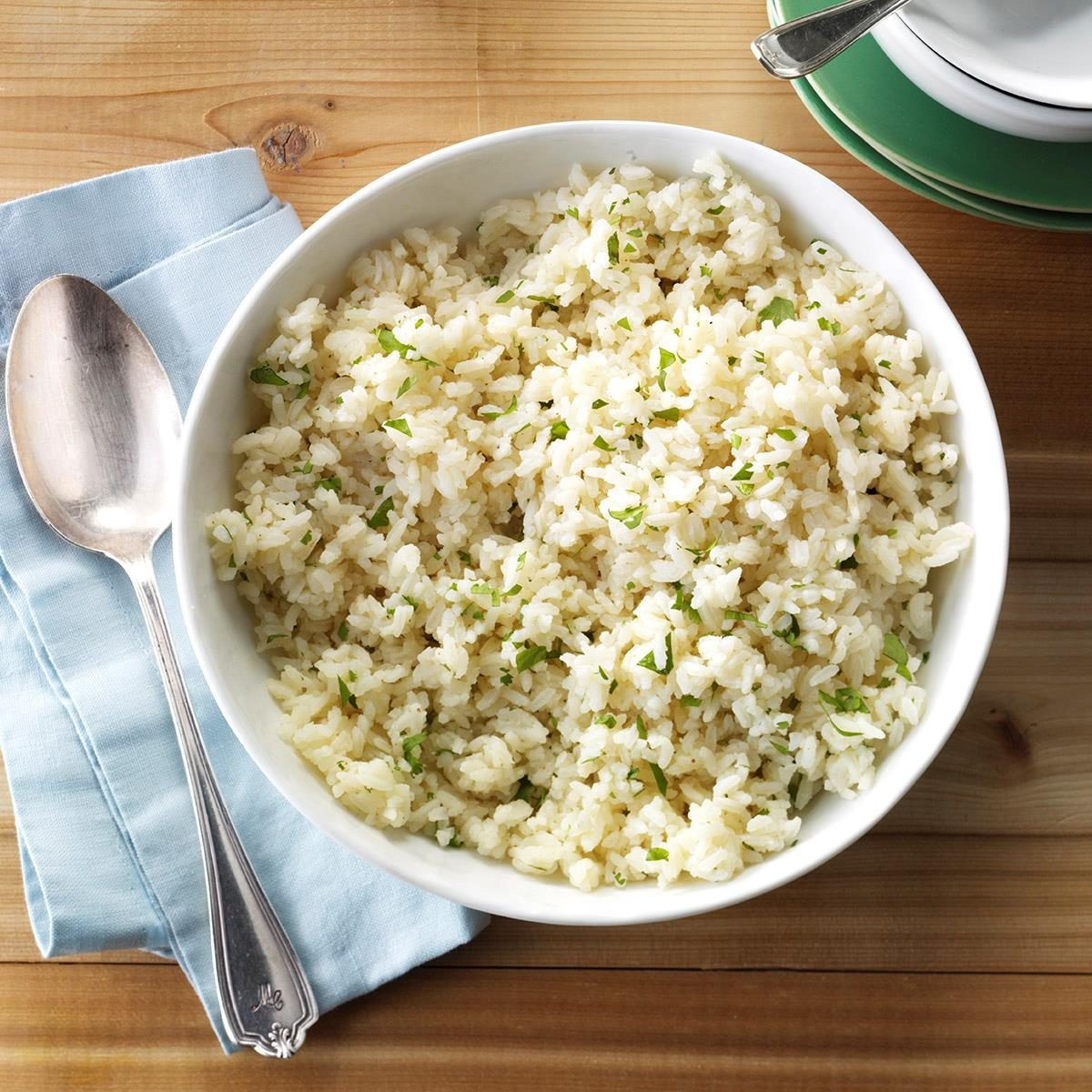 A vibrant bowl of cilantro lime rice, a classic Mexican side dish, showcasing fluffy white rice mixed with fresh cilantro and lime zest, perfect as an accompaniment to various Mexican dishes.