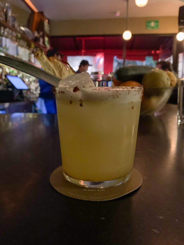 Artfully crafted cocktails at Limantour, showcasing vibrant colors and garnishes.
