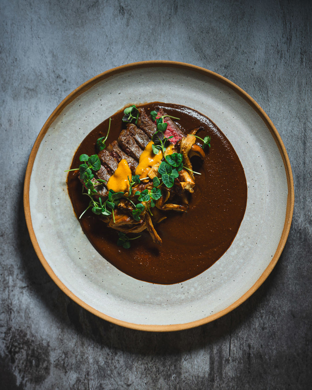 Mole poblano with New York steak showcasing innovative Mexican cuisine in Portland.