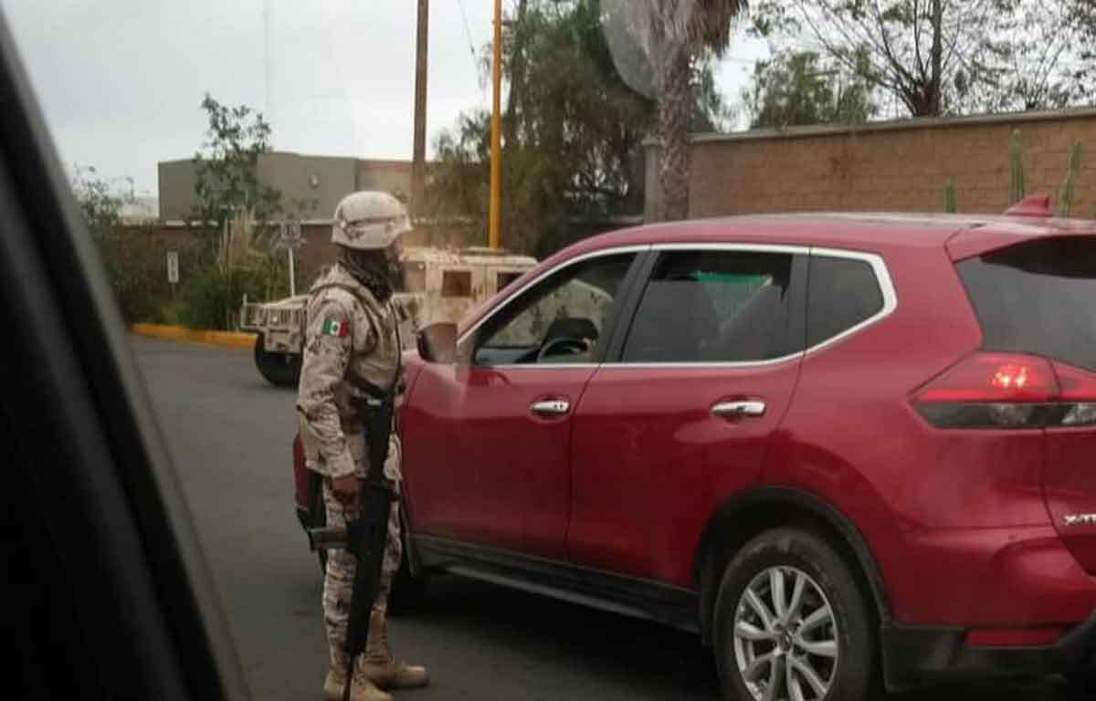 Mexican military inspecting a vehicle outside of Rosarito, illustrating the presence of law enforcement and the importance of knowing how to interact with authorities in Mexico.