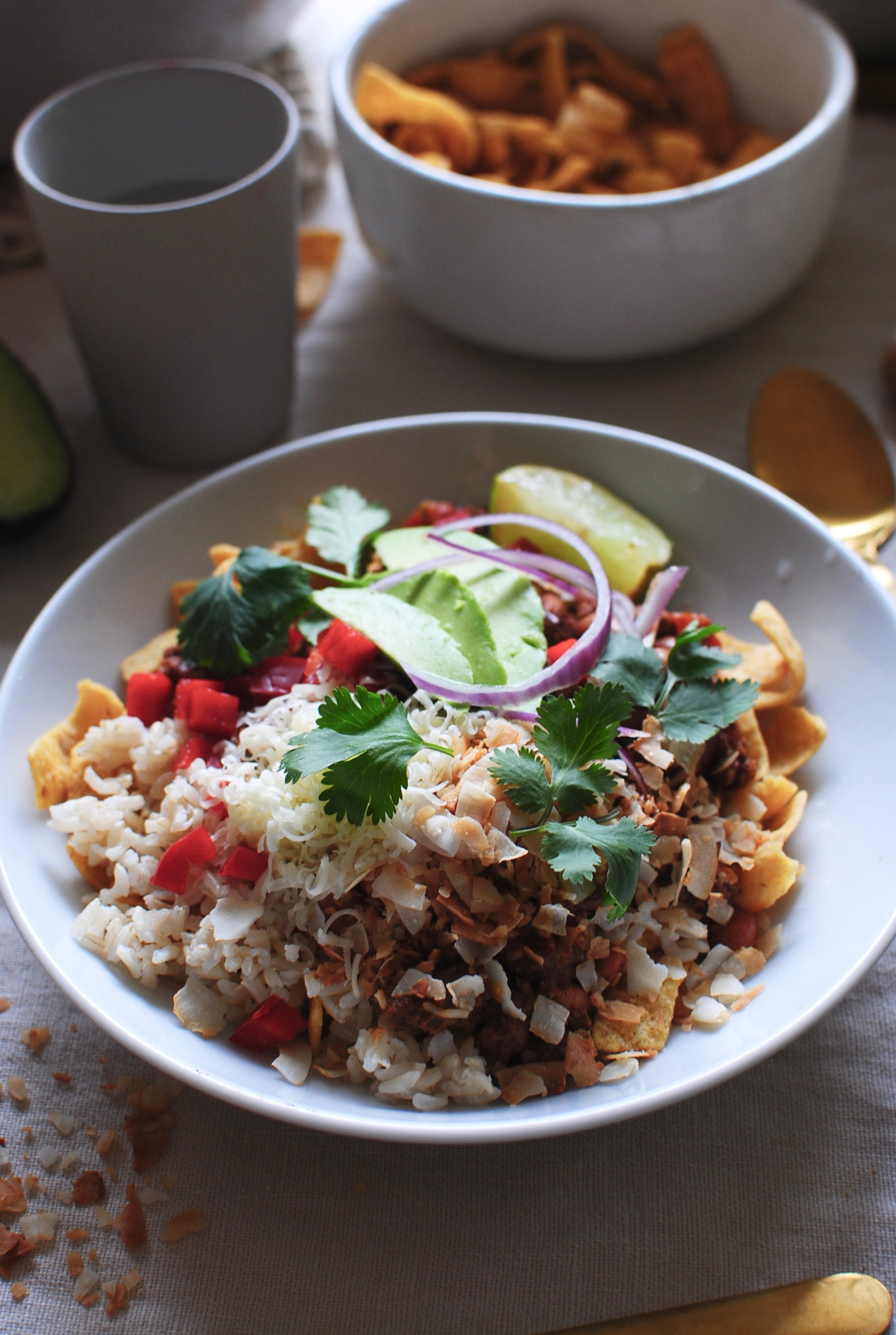 Delicious toppings for Mexican Fiesta Bowls: red bell pepper, red onion, avocado, cilantro, and cheddar cheese.