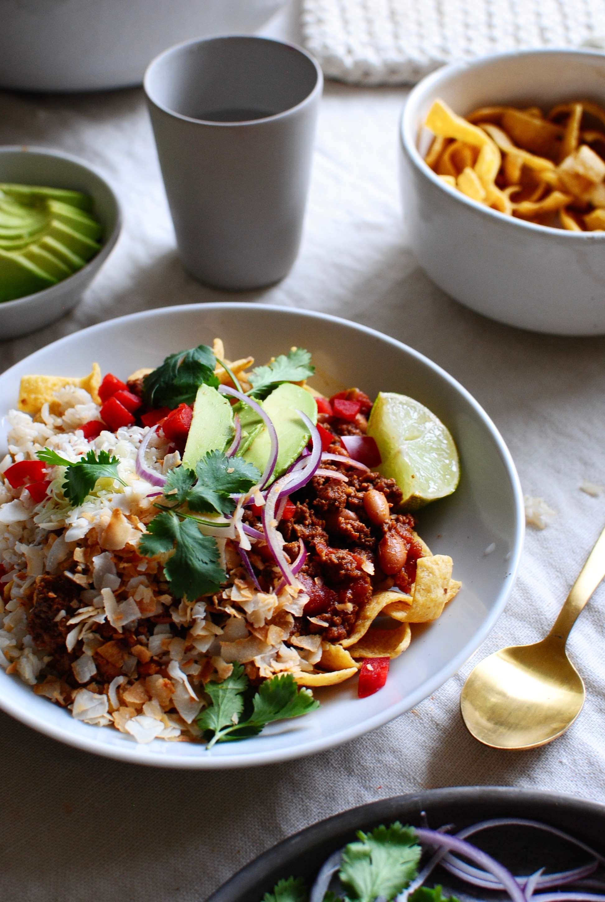 Adding a squeeze of fresh lime juice to a homemade Mexican Fiesta Bowl for extra zest.