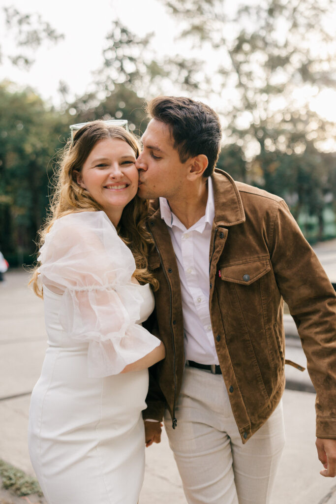 Mexico City couple pictures:  A stylish pair pauses on a Roma Norte street, capturing the essence of urban romance in Mexico