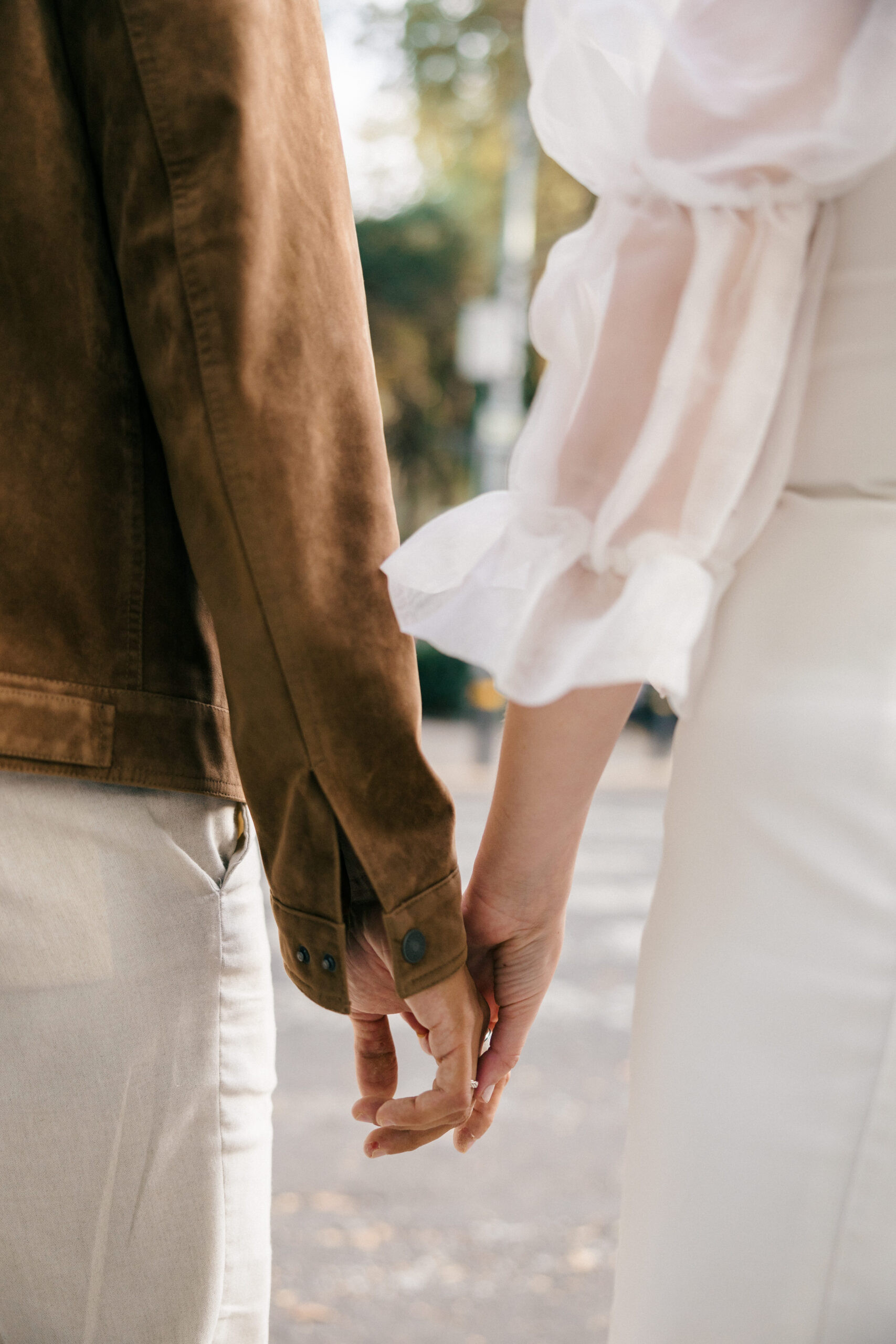 Holding hands mexico pictures: A loving couple holds hands tightly, capturing a sweet and intimate moment during their engagement photos