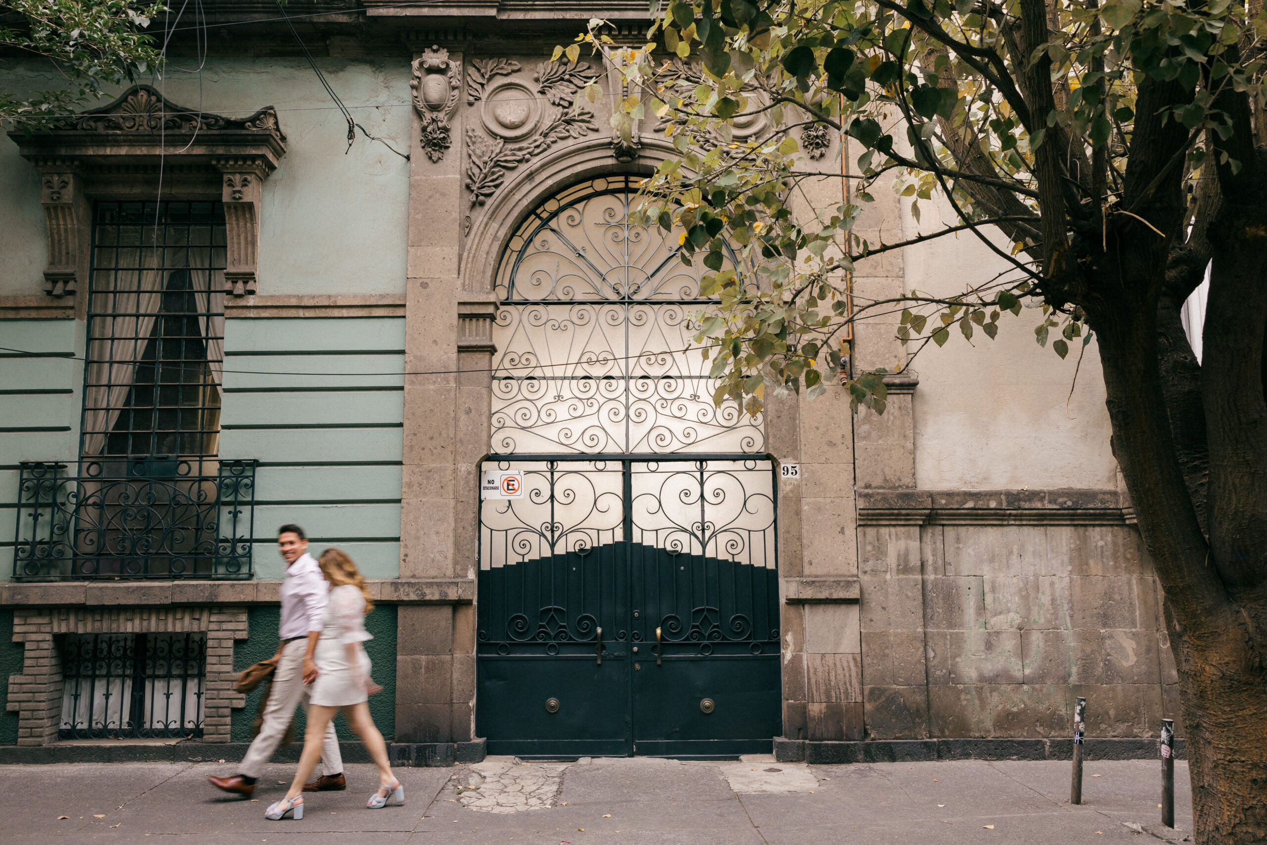 Mexico City street pictures: A beautiful couple strolls hand-in-hand along a picturesque street in Roma Norte, Mexico City