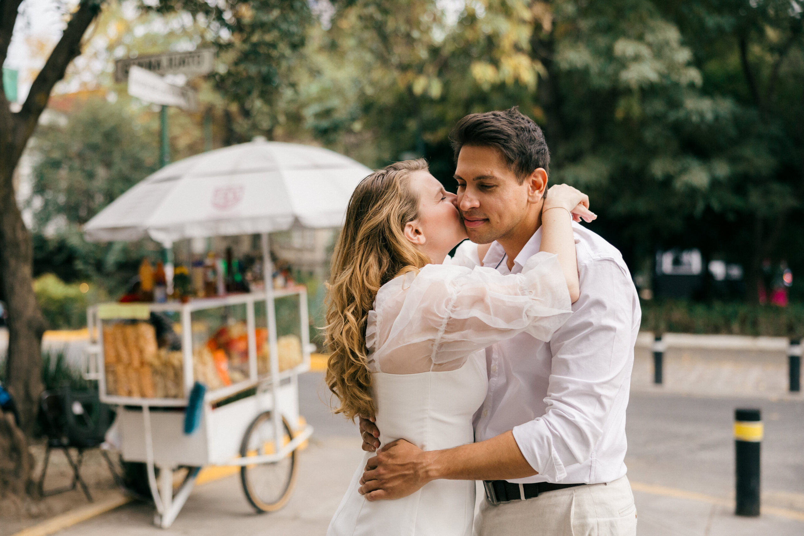 Passionate mexico pictures: A couple shares a tender kiss during their golden hour engagement session in Mexico City's Roma Norte