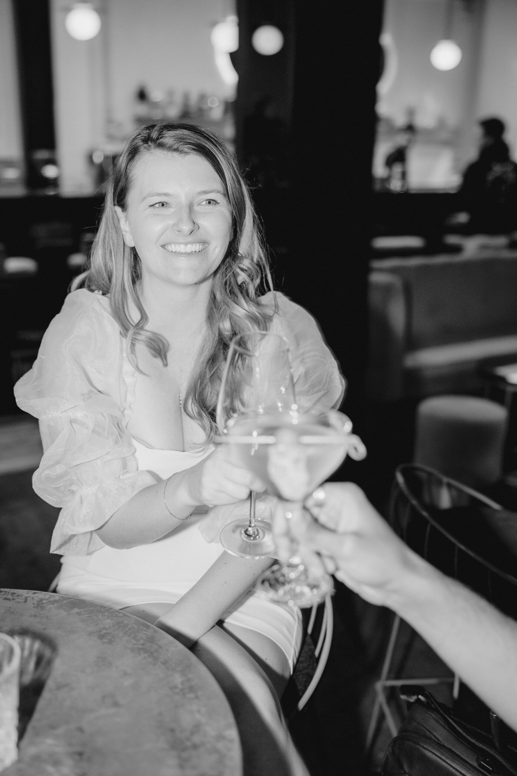 Celebratory mexico pictures: A joyful bride-to-be raises a toast, capturing a moment of celebration during her engagement photoshoot in Mexico