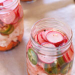 Close-up of vibrant Mexican escabeche with cauliflower, carrots, radishes, and jalapenos