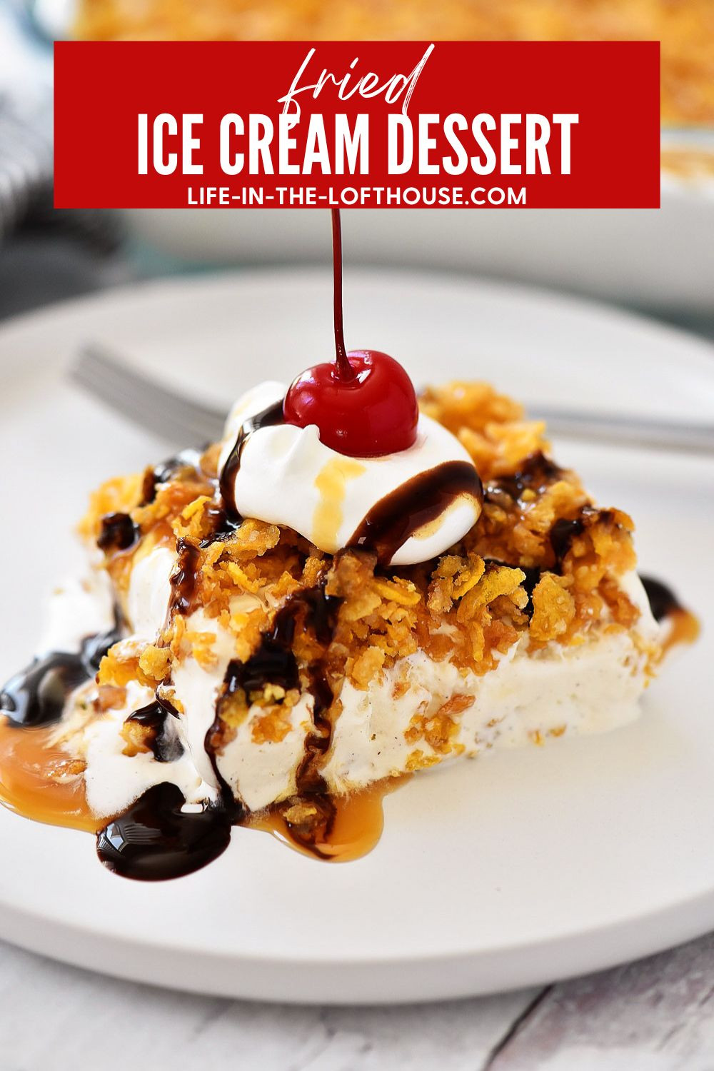 A piece of Mexican Fried Ice Cream Dessert on a plate, showcasing its texture and toppings, with a spoon ready for serving.