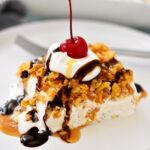 Close-up of Mexican Fried Ice Cream Dessert showcasing its crispy cornflake crust, creamy cinnamon ice cream center, and drizzled chocolate and caramel sauces.