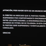 Message displayed on the LED screen warning fans about discriminatory behavior.