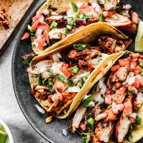 Close-up of Mexican chicken street tacos with vibrant pico de gallo, cilantro, and lime, recipe details below.