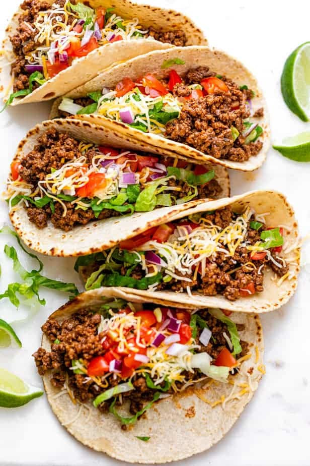 top down shot of beef tacos on white background